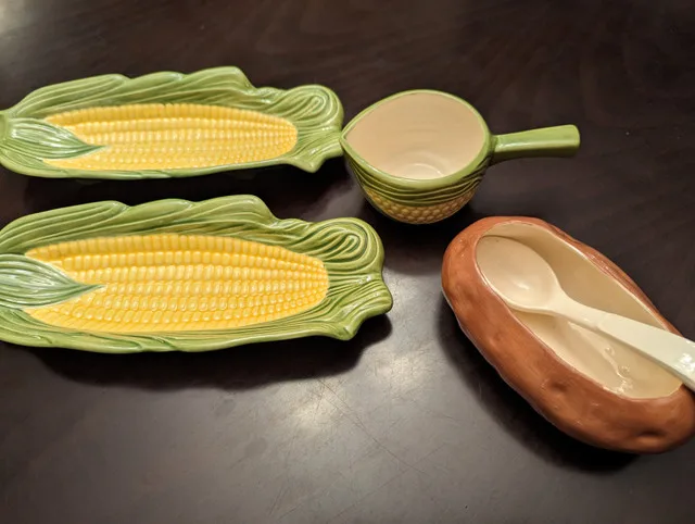 Adorable quirky serving dishes, corn on the cob, baked potato