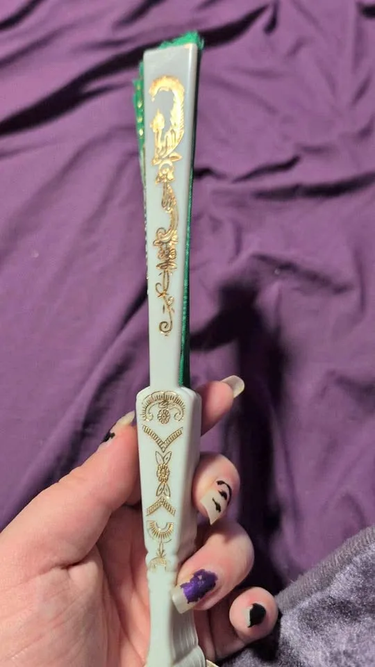 Green and gold hand fan thumbnail