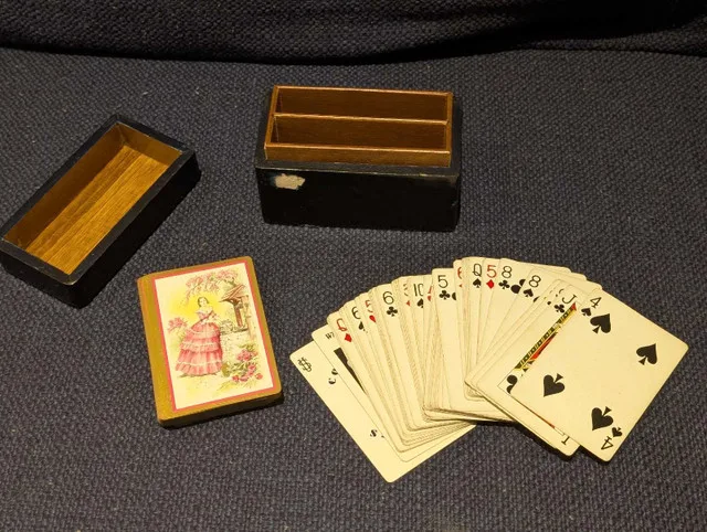 Vintage girls in dress playing cards