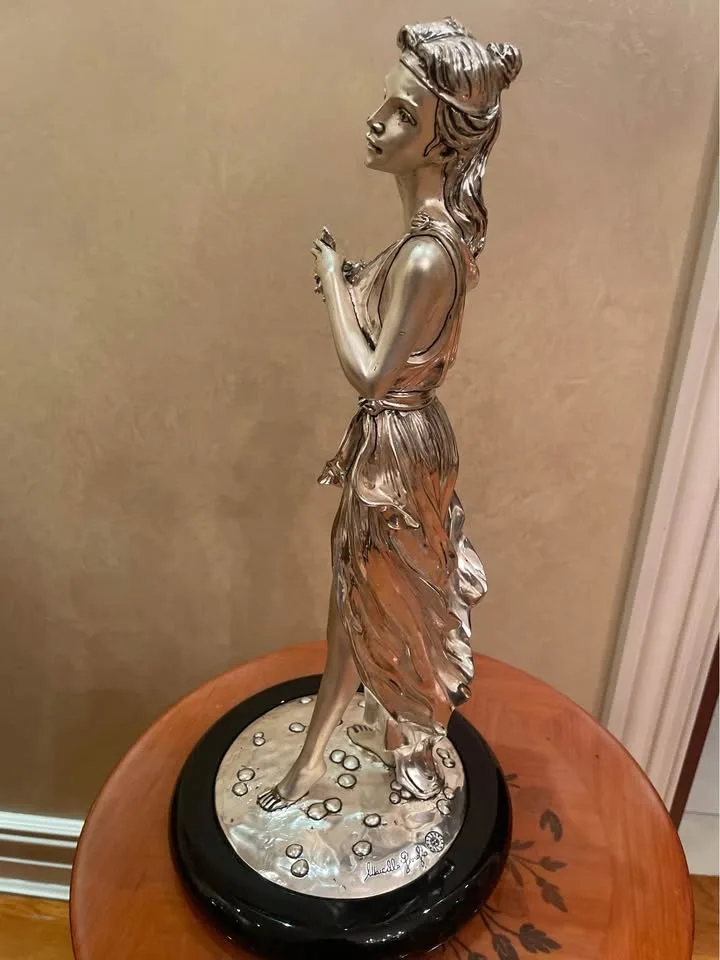 Silver statue of lady with grapes image indicator(3)