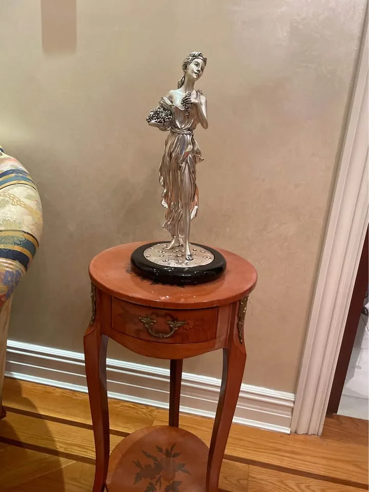 Silver statue of lady with grapes image indicator(7)