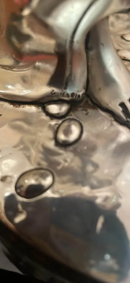 Silver statue of lady with grapes image indicator(9)