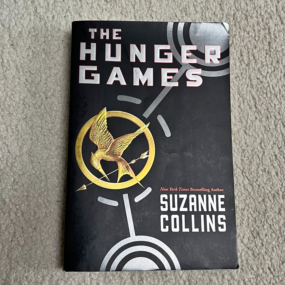 The Hunger Games - by Suzanne Collins (1st Book)