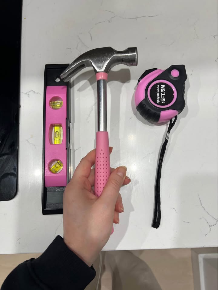 Pink Tools: leveler, hammer, measuring tape