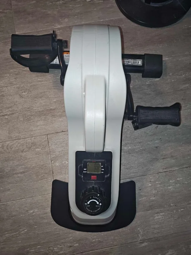 Stationary under the desk pedal machine