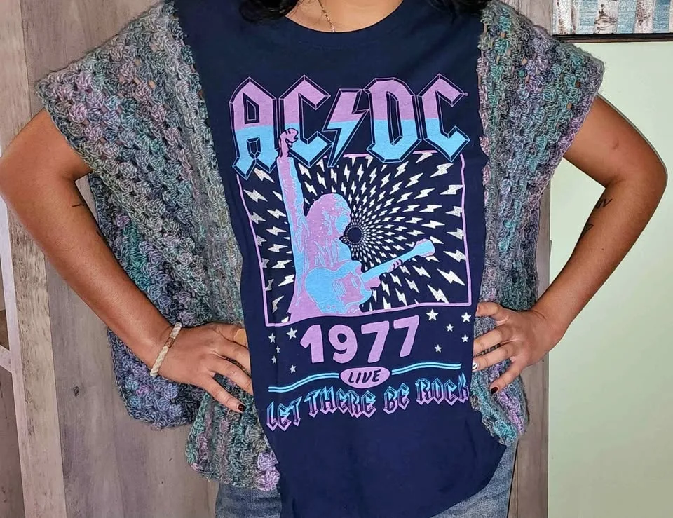 Upcycled AC/DC Ponco. Will fit up to a size small.
