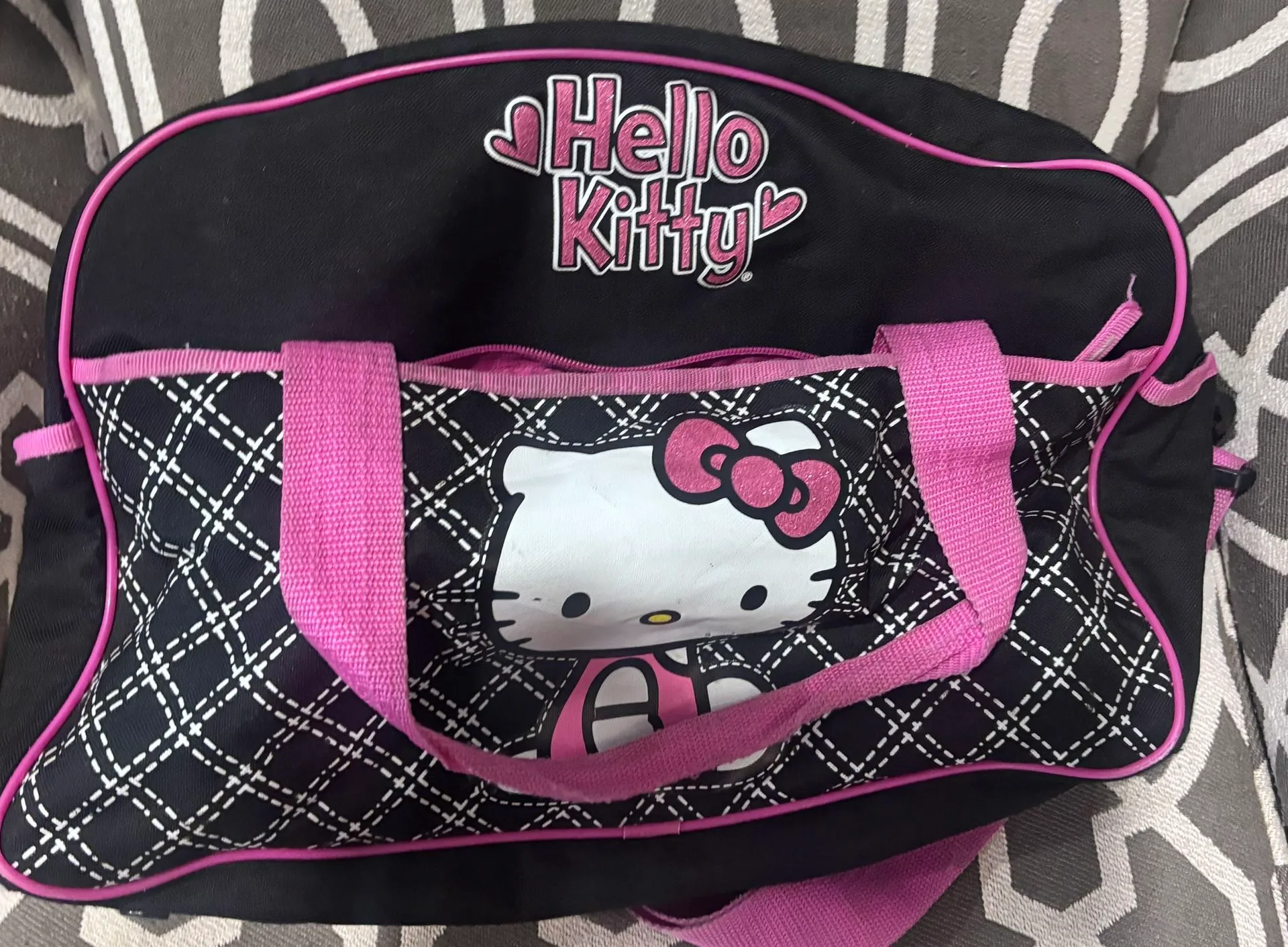 Super cute Hello Kitty duffel bag in black with pink trim and qu