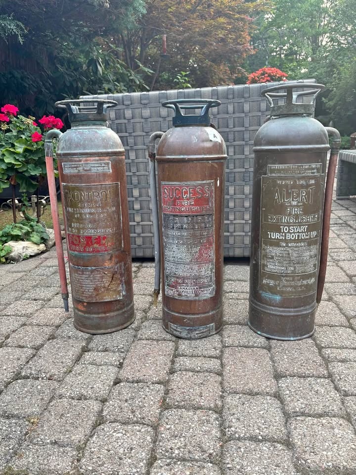 Three vintage brass fire extinguishers