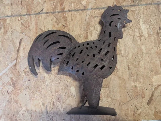 Metal rooster sculpture with candle holder built in