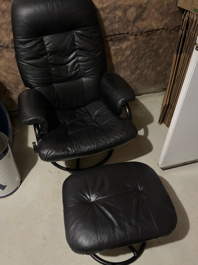 comfortable black chair and ottoman