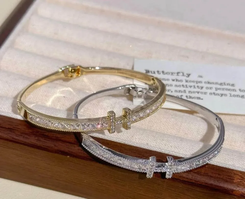 gold-Platted bangle bracelet with a - encrusted "H" initial image indicator(5)