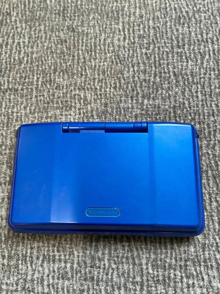 Nintendo DS with charger and games (leaf green and rugrats sold