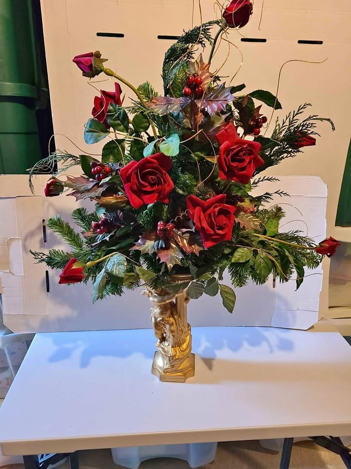 Silk flowers arrangement on a golden ceramic angel