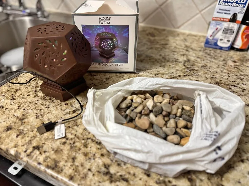 LED projector light + pebbles/stones
