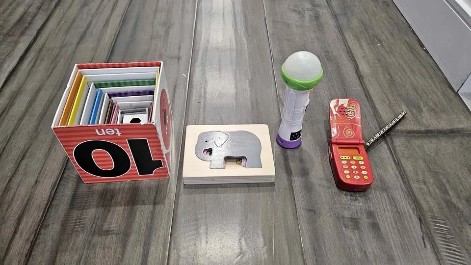 Toy pyramid, microphone, phone, puzzles