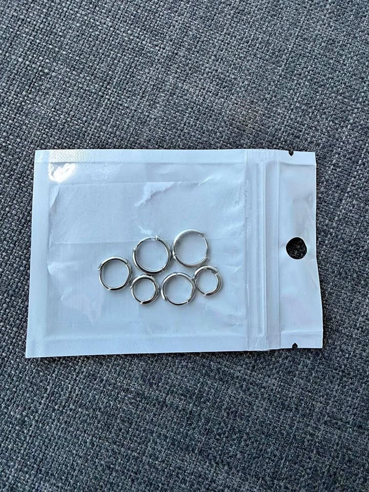 A set of earrings - three pairs of silvery hoops - NEW