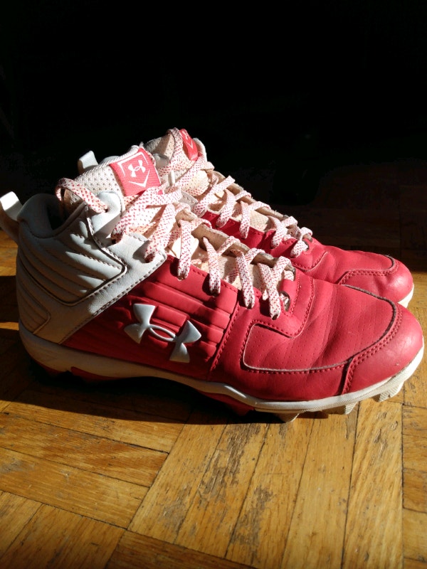 Red UnderArmour baseball cleats mid