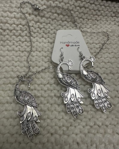silver-tone peacock jewelry set including a necklace and matchin