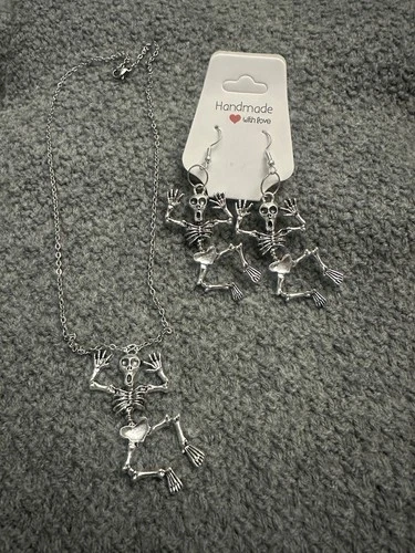 pair of silver-toned articulated skeleton dangle earrings With N