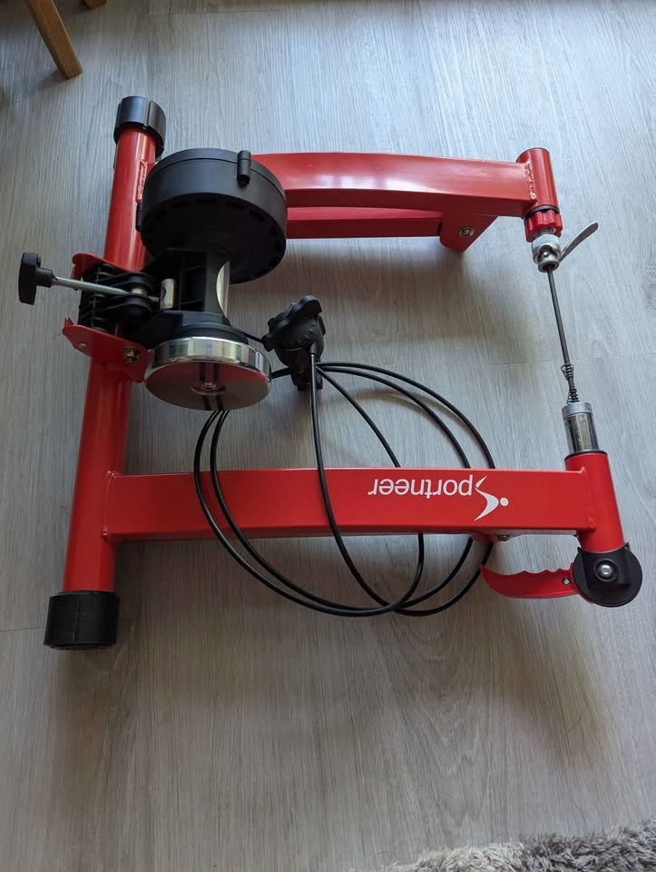 Indoor bicycle trainer with adjustable resistance.