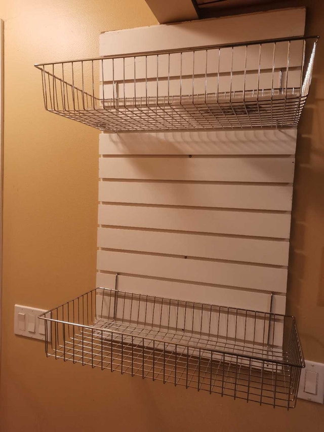 display wall pegboard with two metal hanging baskets
