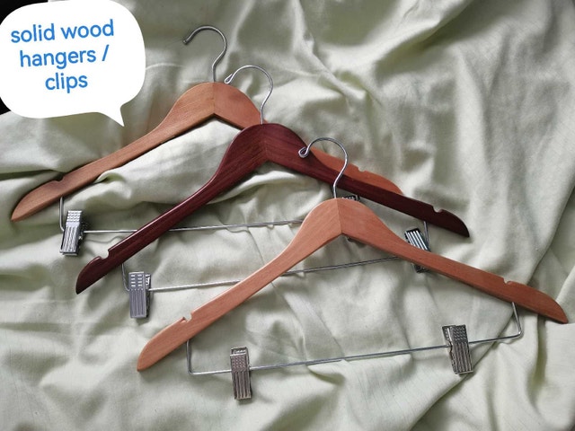 3 wooden hangers with clips
