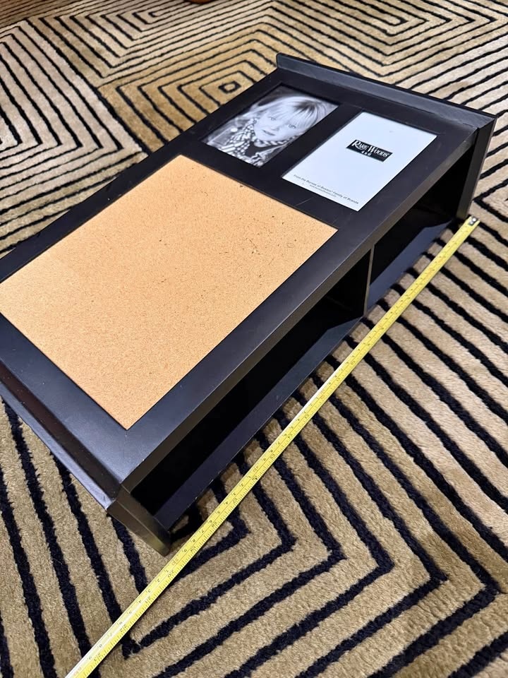 Black wall organizer with photo frames