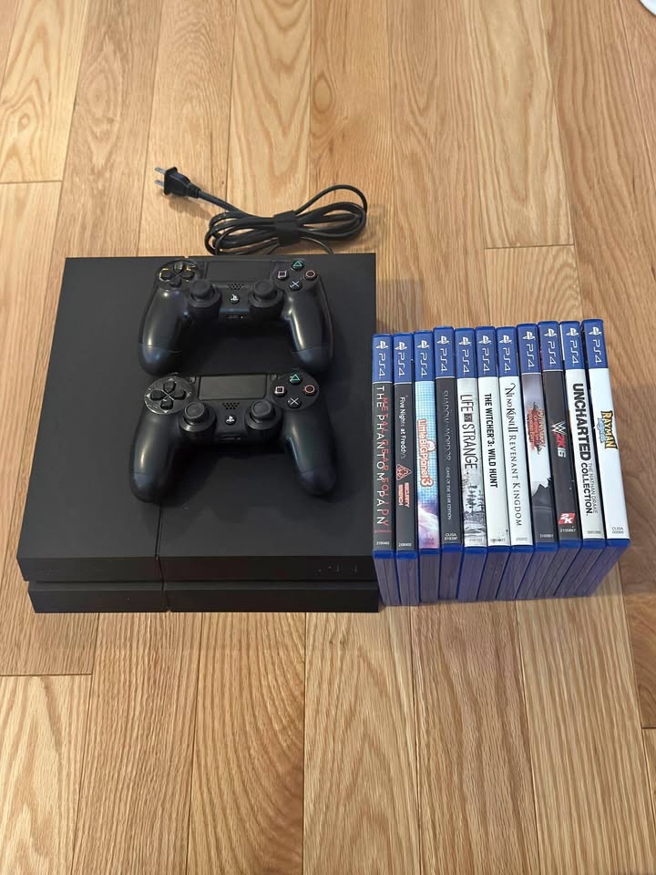 PS4 console with 2x controllers, power adapter and 11x games.