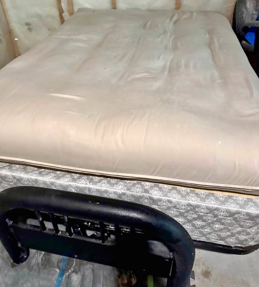 Full size black metal futon with cream mattress
