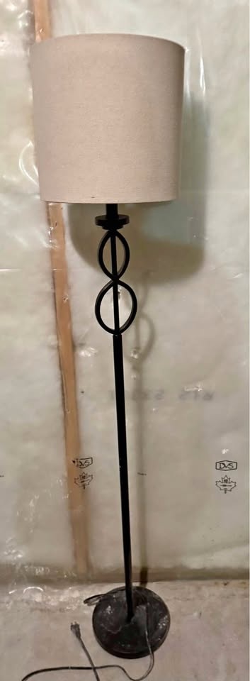 Tall living room light, black base and cream lamp.