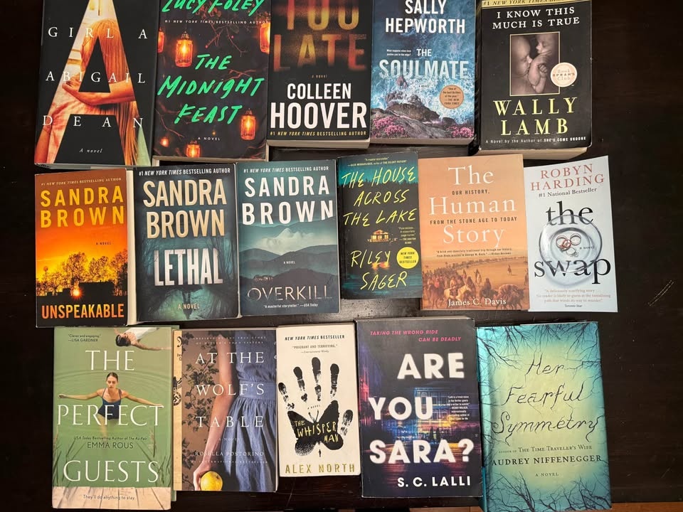 Basket of 16 gently used books. A mix of hardcover and paperback