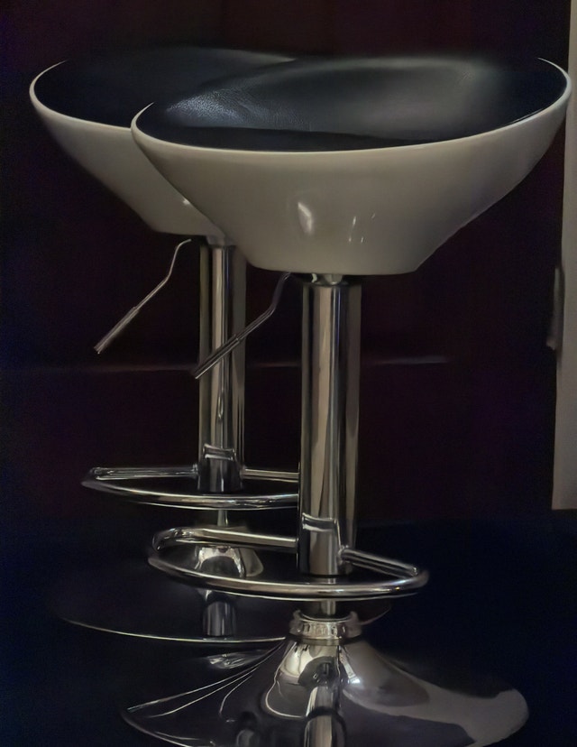 Two bar stools, white plastic