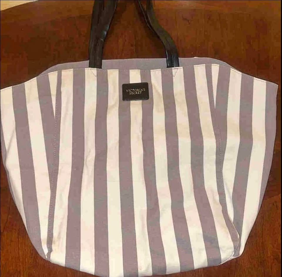 Large grey and white striped beach bag with black handle