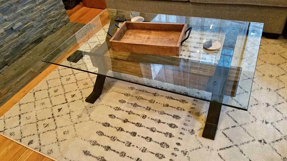 Glass coffee table with wooden cross beam