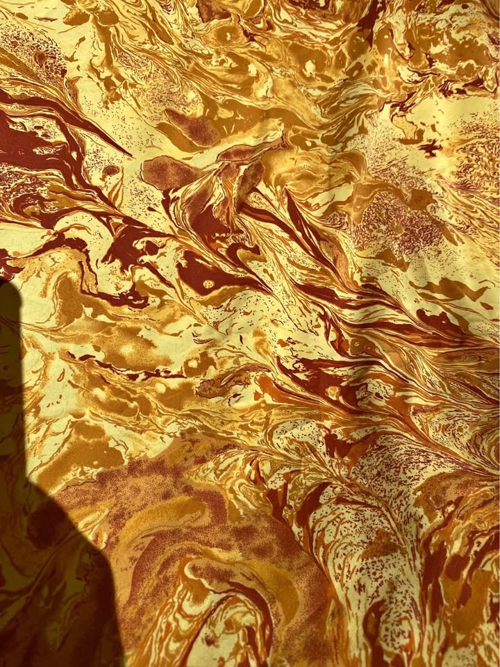 Abstract orange and red swirl rayon fabric