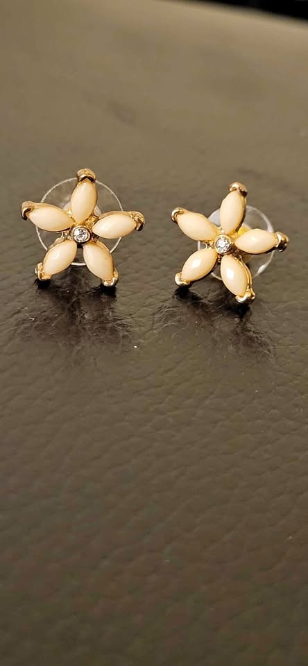Gold tone flower stud earrings with sparkle center