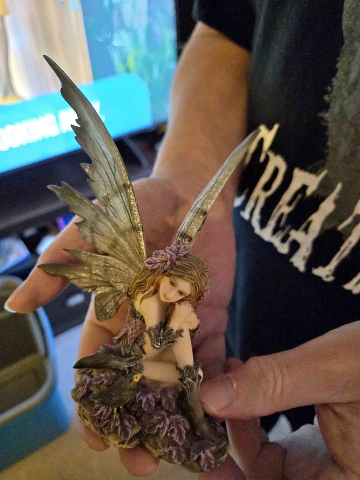 Small fairy statue located in woodbine
