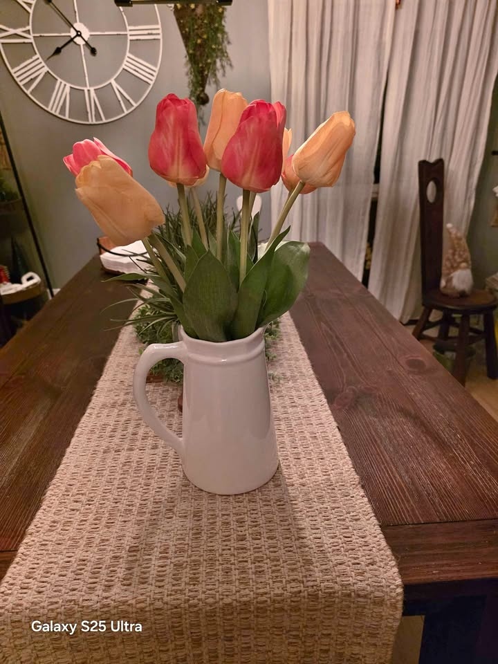 Pitcher with flowers yellow and orange tulips