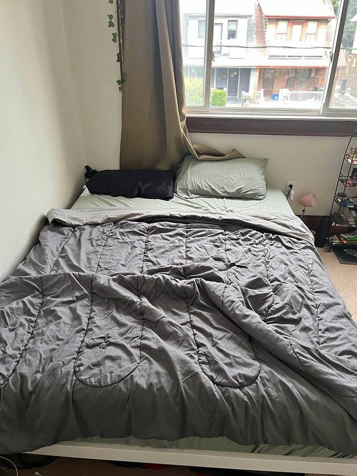 Queen bed frame with mattress and comforter