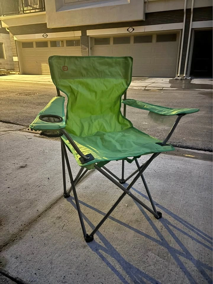Green folding camping chair with cup holder