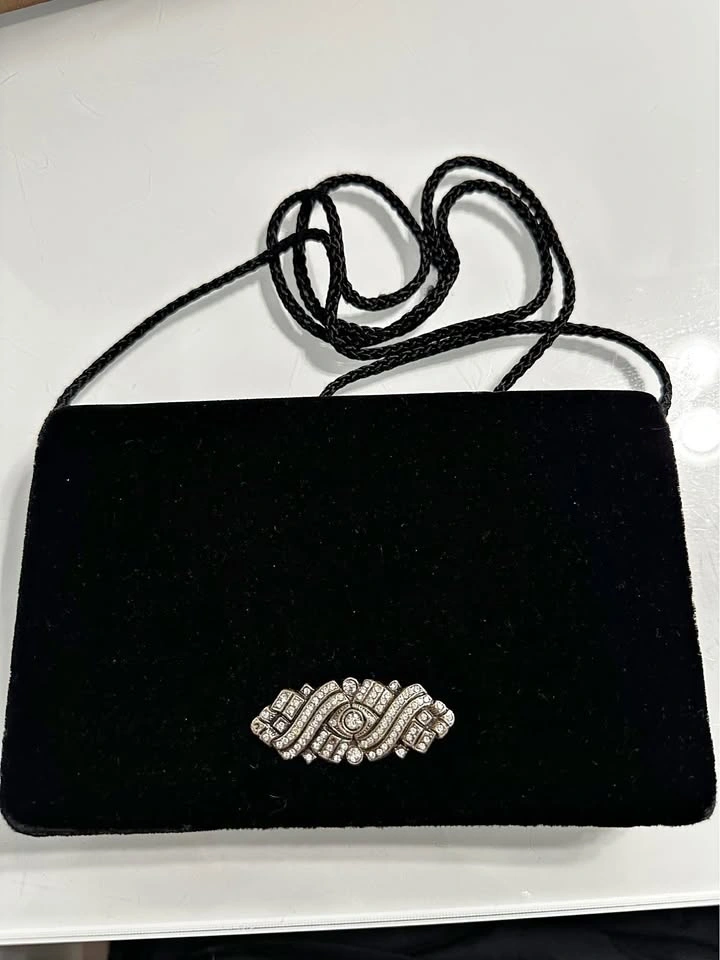 Black velvet clutch with sparkly rhinestone brooch