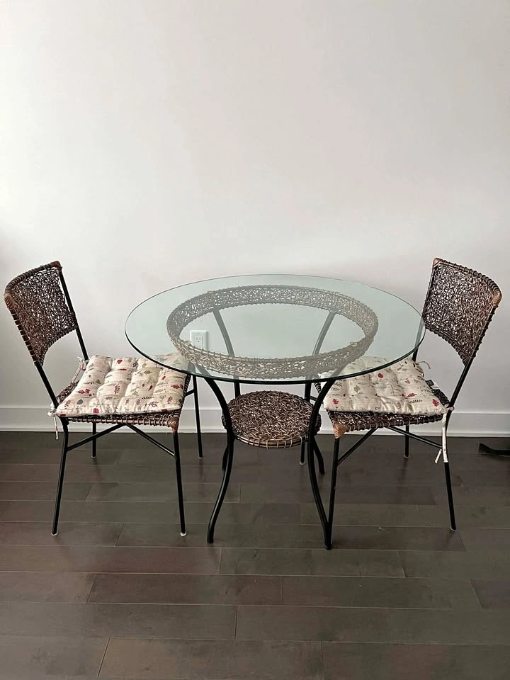 Round glass dining table with two chairs