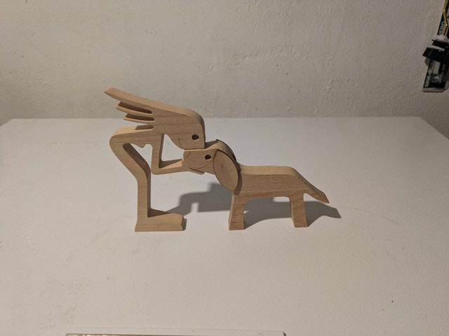 Wooden dog and girl figurine