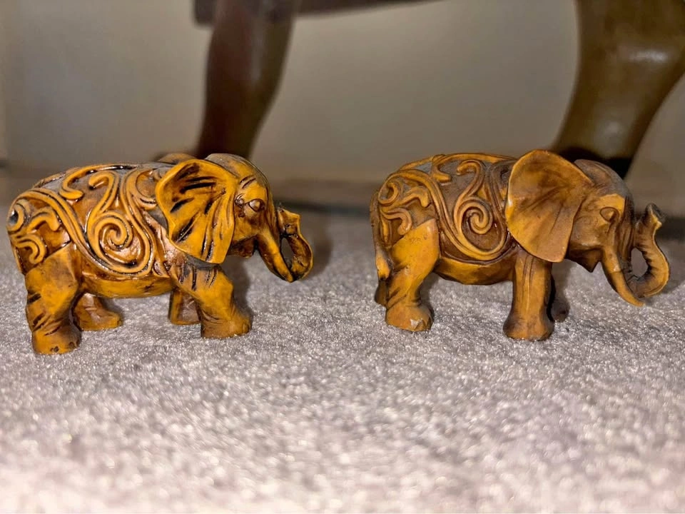Pair of intricate resin elephant figurines