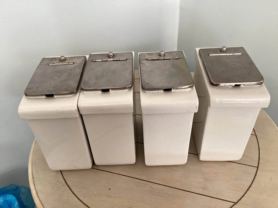 Four matching vintage condiment containers