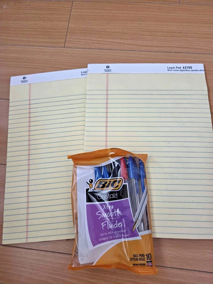 Two yellow note pads and a pack of pens (new)