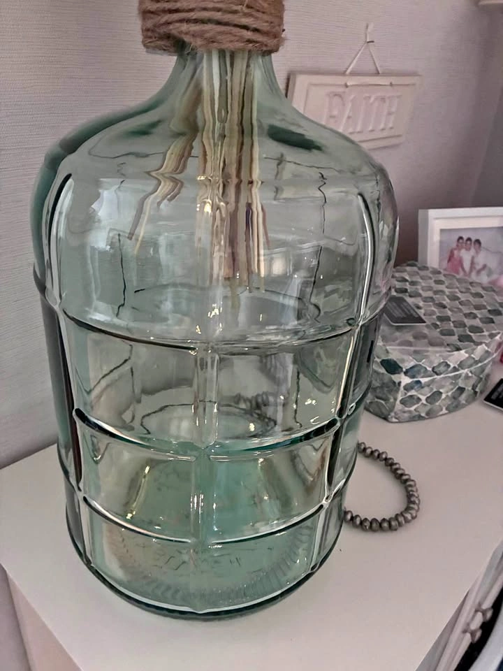 Beautiful decorative glass demijhon with pampas grass.