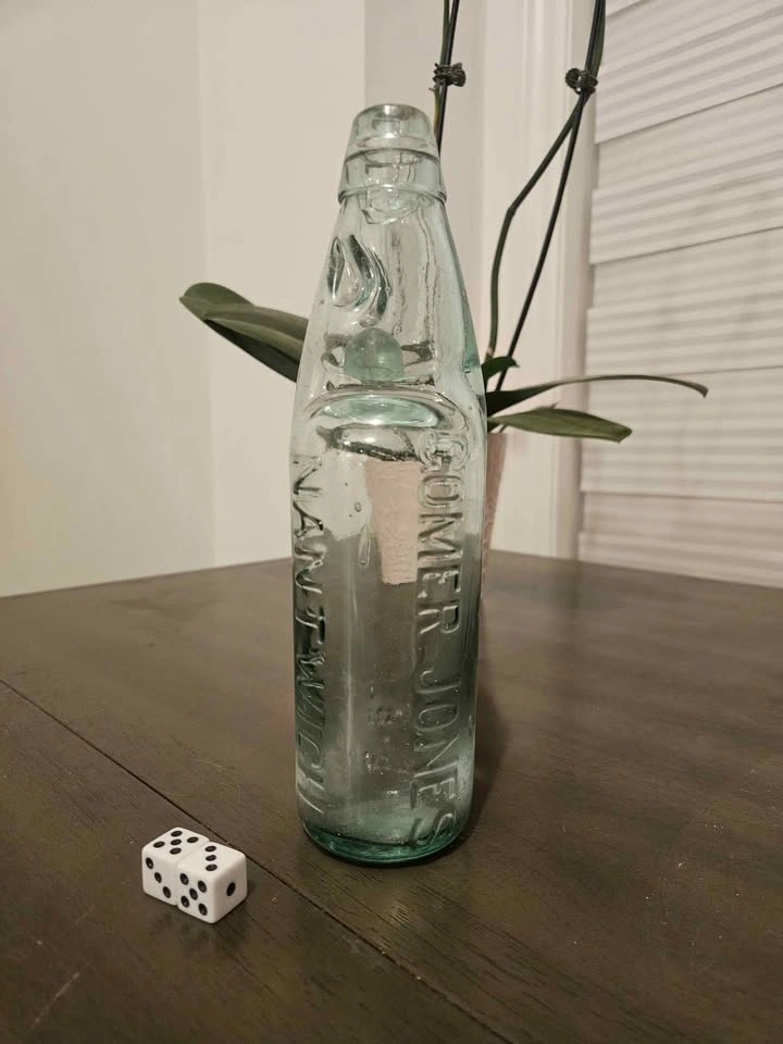 Antique glass soda bottle with marble still inside