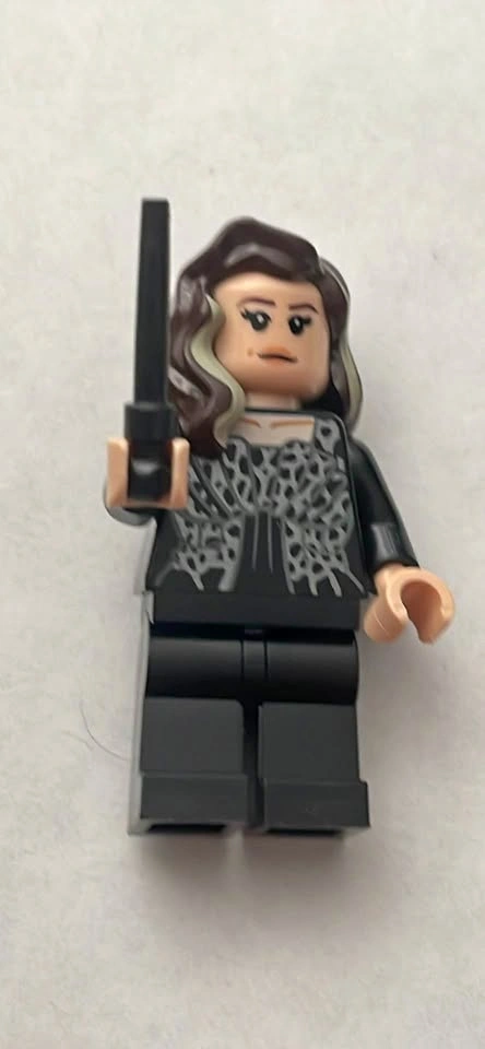 LEGO minifigure with brown and blonde streaked hair and a black