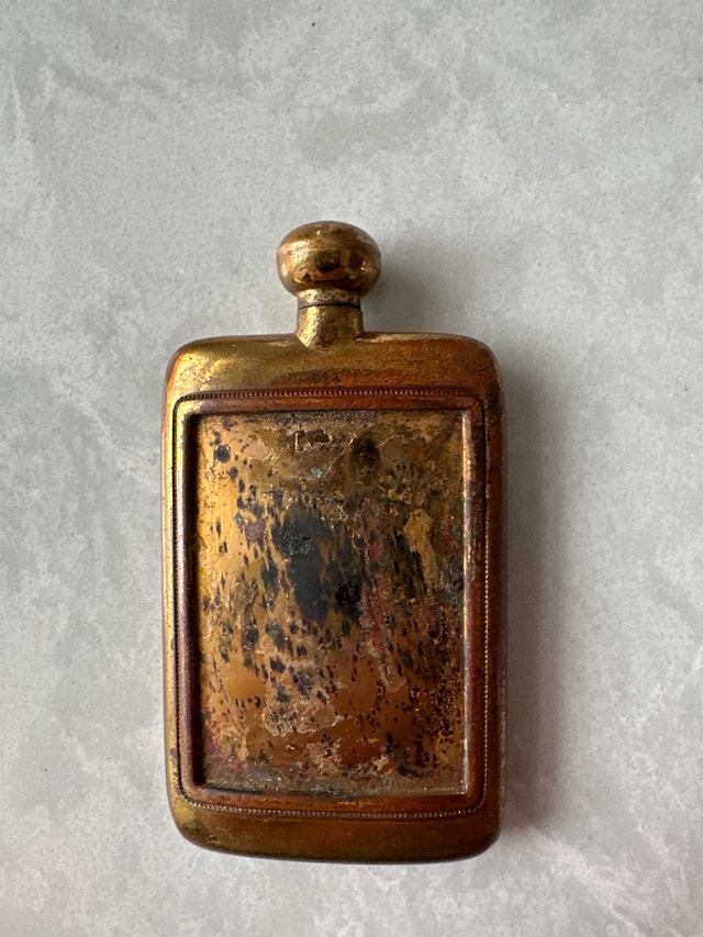 Vintage tiny brass perfume bottle.
